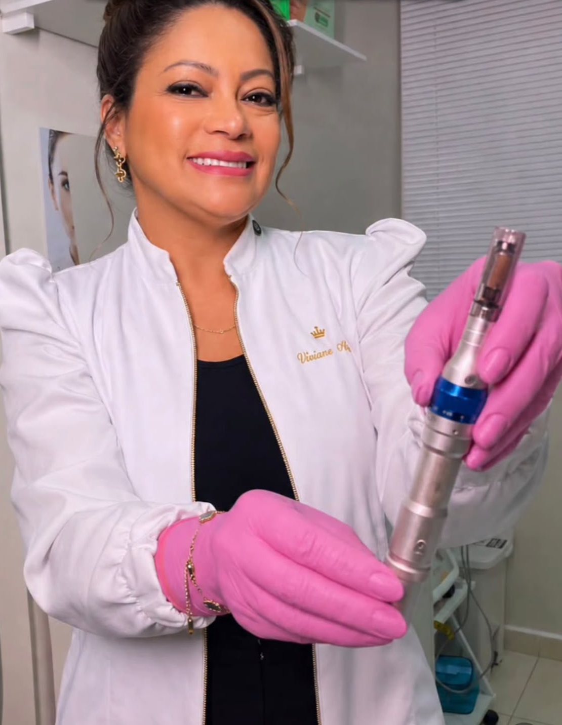 Dra. Viviane Abreu segurando a caneta de microagulhamento no consultório